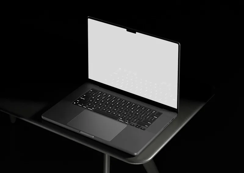 Open laptop with a clean white screen on a desk — the blank starting point before opening a design tool like Canva