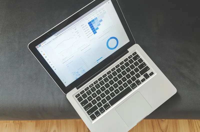 Overhead view of a laptop screen showing data visualizations and charts — the kind of analytics view you see in an email delivery dashboard