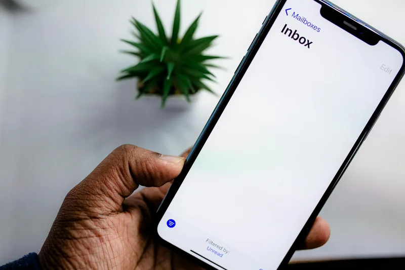 A smartphone showing a welcome email in an inbox, with a clear download link for a lead magnet